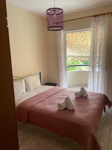 a bedroom with a bed with two towels on it at Stella's Apartment in Alexandroupoli