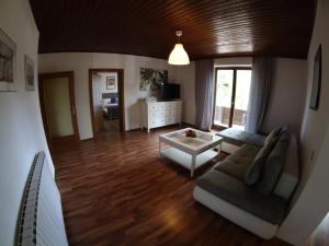 a living room with a couch and a table at Haus im Park in Sankt Kanzian