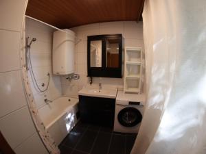 a bathroom with a sink and a washing machine at Haus im Park in Sankt Kanzian +13 photos