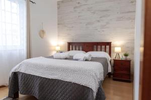 a bedroom with a large bed with towels on it at Casa Borda da Rocha in Nordeste