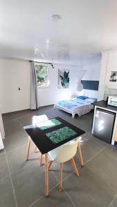 a living room with a table and a bed at Palm Activity in Saint-Pierre