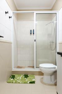 a bathroom with a shower and a toilet at Casa Borda da Rocha in Nordeste +37 photos