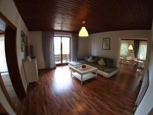 a living room with a couch and a table at Haus im Park in Sankt Kanzian