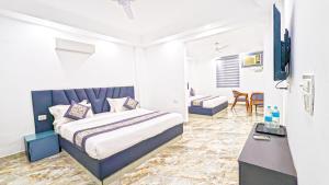 Postel nebo postele na pokoji v ubytování HOTEL GREEN VEGAS