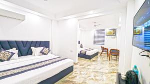 Postel nebo postele na pokoji v ubytování HOTEL GREEN VEGAS