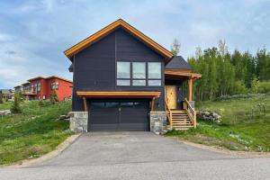 a house on a hill with a garage at A Slice of Silverthorne in Silverthorne