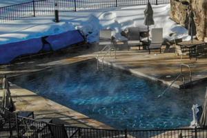a large swimming pool with snow on top of it at A Slice of Silverthorne in Silverthorne