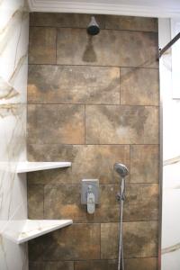 a bathroom with a shower with two shelves at Comfy Apartments Center in Nikiti +42 photos