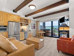a kitchen with a couch and a table in a room at Newpark by All Seasons Resort Lodging in Park City