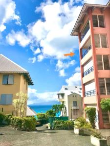 an airplane in the sky above a building at Horizon Mer in Le Gosier
