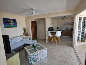a living room with a couch and a table at Horizon Mer in Le Gosier