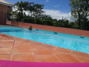 a woman swimming in a swimming pool at Horizon Mer in Le Gosier