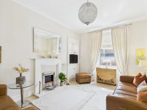 a living room with a couch and a fireplace at Duke Street Suite in Hawick