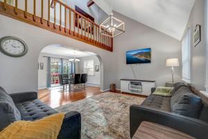 a living room with a couch and a clock at Pocono Chalet Towamensing with Hot Tub Lake and Pool in Albrightsville