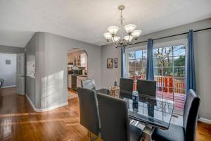 a dining room with a glass table and chairs at Pocono Chalet Towamensing with Hot Tub Lake and Pool in Albrightsville