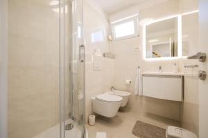 a white bathroom with a toilet and a shower at Villa Mir Punta Radman in Petrcane +118 photos