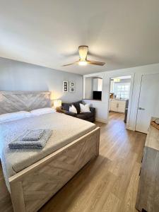 a bedroom with a bed and a ceiling fan at 2 Beachfront Condos Sunset Suites 4 and 5 in Old Orchard Beach