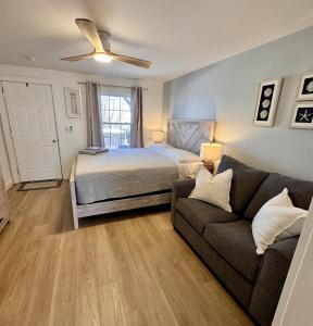 a living room with a bed and a couch at 2 Beachfront Condos Sunset Suites 4 and 5 in Old Orchard Beach +35 photos