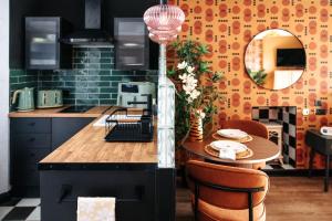 a kitchen with a table with chairs and a mirror at 70s Hideaway Guest Studio for 2 I Private I Self Contained I Near Cardiff in Cardiff +13 photos