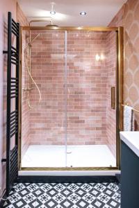 a shower with a glass door in a bathroom at 70s Hideaway Guest Studio for 2 I Private I Self Contained I Near Cardiff in Cardiff