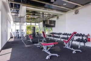 a gym with red chairs and equipment in a room at Sutera Avenue Homestay , Opposite Imago , Kota Kinabalu in Kota Kinabalu