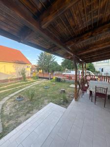 a large patio with a table and chairs on it at Balika vendégház in Tiszaújváros