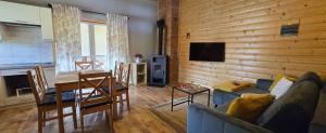 a living room with a couch and a dining room at M&M Dom wakacyjny in Wicie