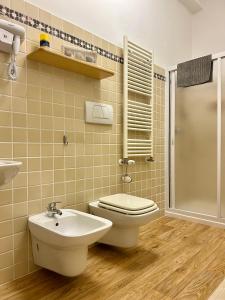 a bathroom with a toilet and a sink and a shower at casa vacanza con balcone in Laterza +2 photos