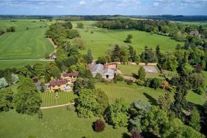 an aerial view of a large house in a field at The Grange, Brockhall 