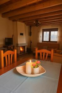 a candle sitting on a table in a living room at Casa Rural La Celestina in Navalmoro