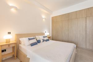 a bedroom with a large white bed and a wooden cabinet at Boka Apartment 3 in Herceg-Novi +30 photos