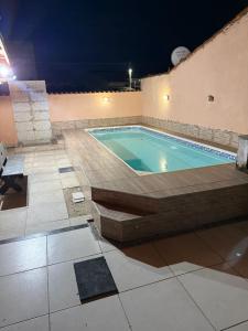 a swimming pool in a building at night at Casa com Piscina em Itaipuaçu in Maricá