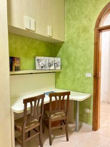 a kitchen with a white table and two chairs at casa vacanza in Laterza