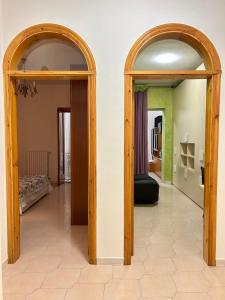 two arched doors in a room with a bedroom at casa vacanza in Laterza +4 photos