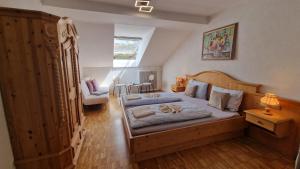 a bedroom with a large bed and a chair at Alpen Hotel Martin in Nesselwang +117 photos