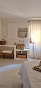 a white room with a bed and a mirror at Apartment C-MM09 in Bussi sul Tirino