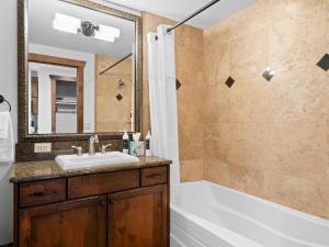 a bathroom with a tub and a sink and a shower at Hyatt Centric by All Seasons Resort Lodging in Park City +26 photos