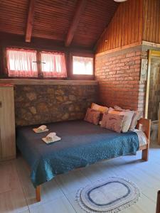 a bedroom with a bed in a brick wall at Apartment Vistanova in Vrdnik