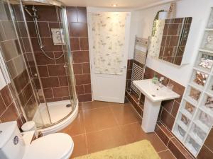 a bathroom with a shower and a toilet and a sink at The Thyme House in Keighley +37 photos