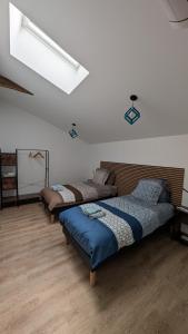 three beds in a room with wooden floors at Les roches voisines "big rock" in Solutré-Pouilly