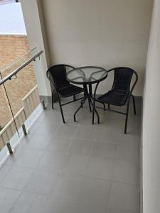 a table and two chairs sitting on a balcony at Seaviews in Lancelin