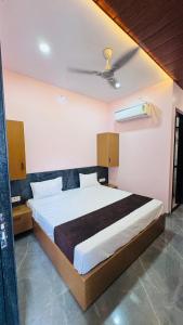 a bedroom with a large bed in a room at Hotel swastik Inn in Ujjain +4 photos
