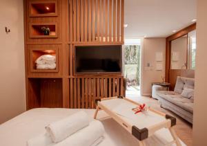 a living room with a bed and a couch at Studios Heaven in Gramado