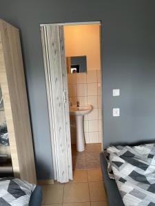 a bathroom with a sink and a mirror at Pokój u Patki in Rowy