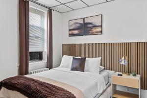 a bedroom with a large bed and a window at Modern Studio - Parking Available - 15 min NYC in Jersey City