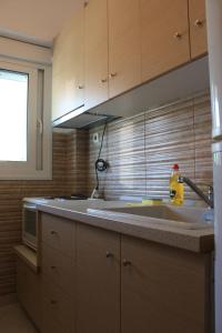 a kitchen with a sink and a counter top at Sunray Studios Asprovalta in Asprovalta +78 photos
