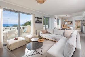 a living room with a couch and a table at Villa Piedra Acharavi in Acharavi