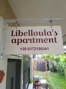 a sign for a litzilliuation appointment hanging outside a house at Libelloula's apartment google it in Lygia