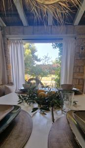 a table with a white table cloth and a window at Apartment Carpe Diem Ivan Dolac in Ivan Dolac