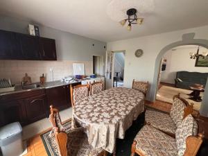 a kitchen with a table and chairs and a kitchen with a sink at Kuća za odmor braća Jevtić Vrnjačka Banja in Vrnjačka Banja
